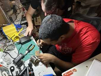 HackerspaceSG members using a new soldering iron